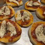Homemade Chilean pizzetas with tomato sauce, cheese and oregano for a birthday party