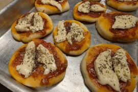 Homemade Chilean pizzetas with tomato sauce, cheese and oregano for a birthday party