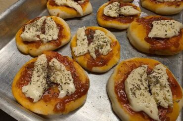 Homemade Chilean pizzetas with tomato sauce, cheese and oregano for a birthday party