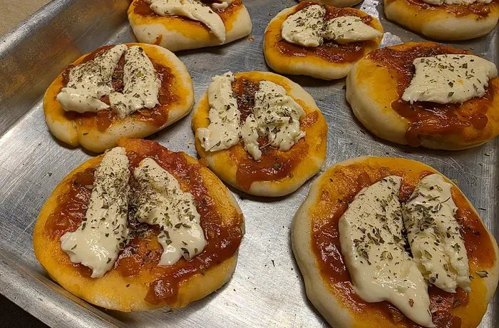 Homemade Chilean pizzetas with tomato sauce, cheese and oregano for a birthday party