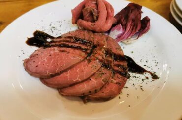 Chilean oven-roasted ribeye cut into pink slices for a holiday dinner