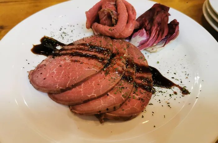 Chilean oven-roasted ribeye cut into pink slices for a holiday dinner