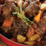 Chilean oxtail braised in red wine with potatoes and carrots in a dark sauce