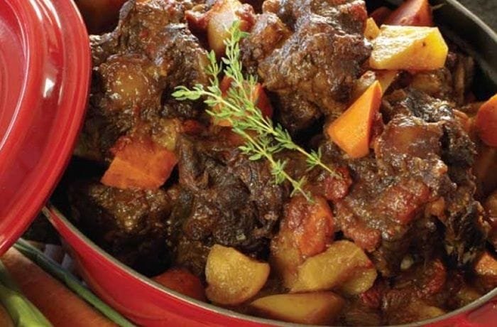 Chilean oxtail braised in red wine with potatoes and carrots in a dark sauce