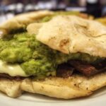 Chilean plateada sandwich with braised beef, mashed avocado, and mayonnaise in a marraqueta