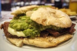 Chilean plateada sandwich with braised beef, mashed avocado, and mayonnaise in a marraqueta