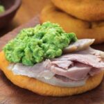 Chilean sandwich of sliced pork leg and mashed avocado between two sopaipillas