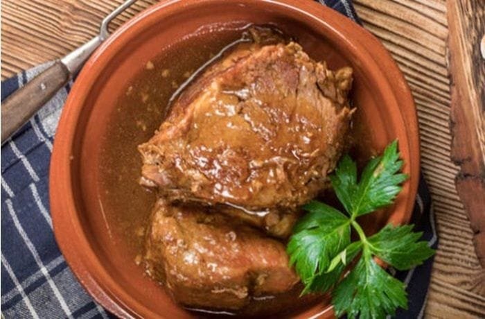 Chilean pot roast, carne a la olla, sliced and served with its vegetable sauce