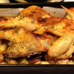 Chilean roast chicken with golden potatoes in a baking dish