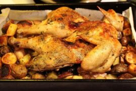 Chilean roast chicken with golden potatoes in a baking dish
