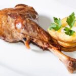 Chilean roast leg of goat, golden and tender, served with its cooking juices