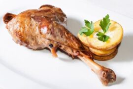 Chilean roast leg of goat, golden and tender, served with its cooking juices