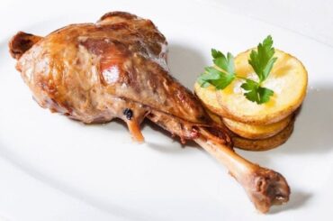 Chilean roast leg of goat, golden and tender, served with its cooking juices