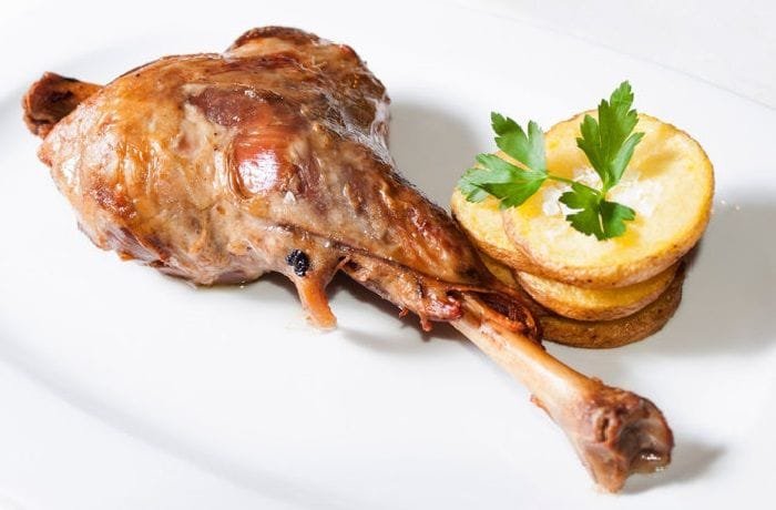 Chilean roast leg of goat, golden and tender, served with its cooking juices