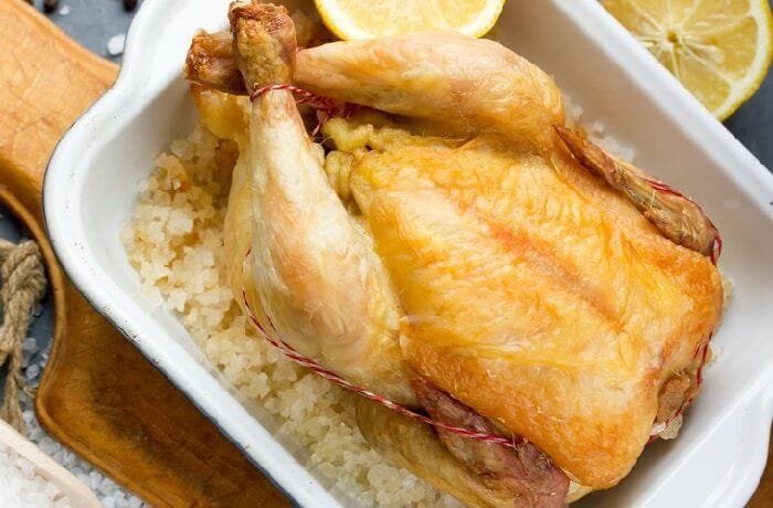 Whole chicken roasted on a bed of coarse salt