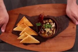 Chilean sea snails al pil pil with garlic and chili served in a clay bowl