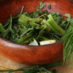 Chilean shallot pebre, a fresh relish of shallots, herbs, vinegar, and merkén in a clay bowl