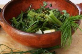Chilean shallot pebre, a fresh relish of shallots, herbs, vinegar, and merkén in a clay bowl