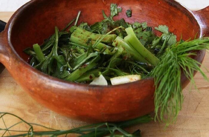 Chilean shallot pebre, a fresh relish of shallots, herbs, vinegar, and merkén in a clay bowl