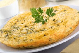 Chilean spaghetti omelette, tortilla de fideos, golden and cut into wedges