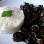 Squid in its own black ink sauce with rice