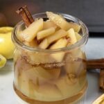 Chilean stewed apples with cinnamon served in dessert glasses with their cooking syrup