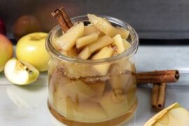 Chilean stewed apples with cinnamon served in dessert glasses with their cooking syrup