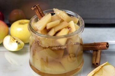 Chilean stewed apples with cinnamon served in dessert glasses with their cooking syrup
