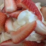 Chilean strawberries and cream served in a glass with whipped cream, a seasonal recipe