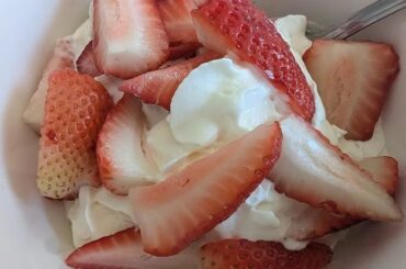 Chilean strawberries and cream served in a glass with whipped cream, a seasonal recipe