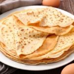 Chilean sweet panqueques, thin crepes rolled with manjar and jam