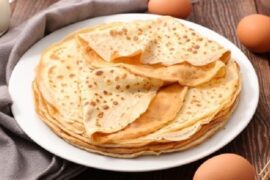 Chilean sweet panqueques, thin crepes rolled with manjar and jam