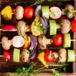 Chilean vegan anticuchos, grilled skewers of artichoke, mushrooms, cherry tomatoes, peppers, onion, and zucchini