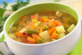 Chilean vegetable soup with potatoes, carrots, squash, and green beans, topped with cilantro