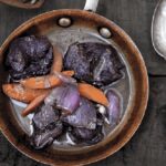 Chilean venison stew braised in red wine with carrots and pearl onions