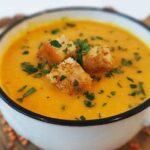 Creamy lentil soup with croutons and cilantro