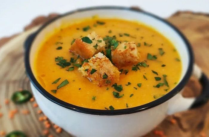 Creamy lentil soup with croutons and cilantro
