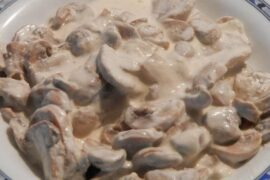Creamy sliced mushroom sauce in a skillet