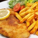 Crispy golden chicken milanesa with lemon