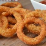 Crispy golden homemade onion rings with dipping sauces
