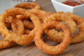 Crispy golden homemade onion rings with dipping sauces