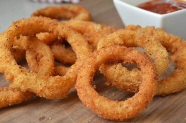 Crispy golden homemade onion rings with dipping sauces