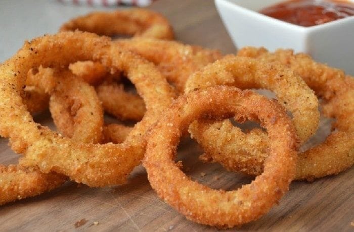 Crispy golden homemade onion rings with dipping sauces