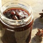 Dark beer jam in a glass jar with spices