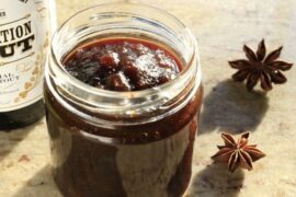 Dark beer jam in a glass jar with spices