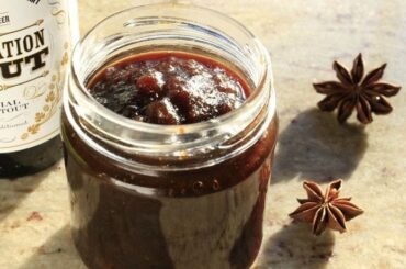 Dark beer jam in a glass jar with spices