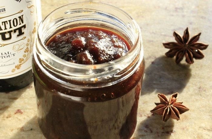 Dark beer jam in a glass jar with spices