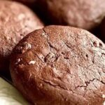 Soft chocolate cocoa cookies on a cooling rack