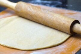Ball of easy homemade pizza dough on a floured surface