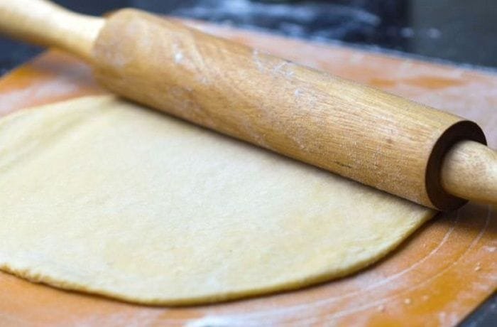 Ball of easy homemade pizza dough on a floured surface